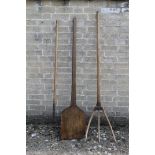 A bread paddle and two vintage hay forks.