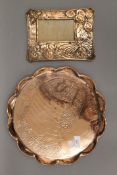 An Arts and Crafts copper tray and Arts and Crafts copper frame. The former 33.5 cm diameter.