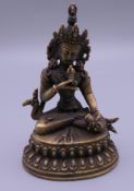 A small bronze model of Buddha. 10 cm high.