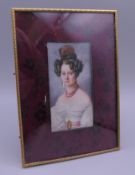 A 19th century miniature portrait of a young lady, in a gilt bronze frame. 13 x 18 cm overall.