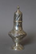 An embossed silver sugar sifter. 19.5 cm high. 189.2 grammes.
