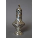 An embossed silver sugar sifter. 19.5 cm high. 189.2 grammes.