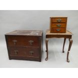 An oak two drawer chest, a side table and a small bank of drawers.