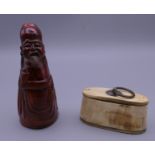 A carved horn figure of a sage and a horn snuff box. The former 11.5 cm high.