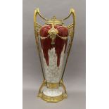 A Continental Art Nouveau brass mounted pottery vase. 69 cm high.