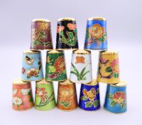 Twelve cloisonne thimbles.