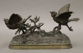 A bronze animalier sculpture formed as two birds taking flight, signed PAUTROT. 28 cm long.