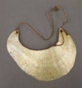 A 19th century Papua New Guinea Kina currency shell. 17 cm wide.