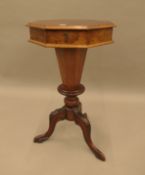 A Victorian walnut trumpet work table. 68.5 cm high.