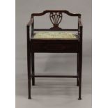 An Edwardian mahogany piano stool. 46 cm wide.