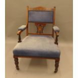 An Edwardian inlaid rosewood open armchair. 60 cm wide.