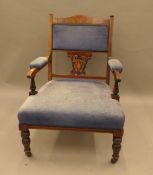 An Edwardian inlaid rosewood open armchair. 60 cm wide.