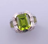 A 14 K white gold peridot and diamond ring. Ring size L/M.