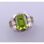 A 14 K white gold peridot and diamond ring. Ring size L/M.