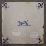 An 18th century Delft tile decorated with a dog. 12.5 cm wide.