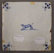 An 18th century Delft tile decorated with a dog. 12.5 cm wide.