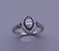 An Art Deco style platinum, sapphire and diamond marquis shape ring. Ring size N/O.