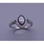 An Art Deco style platinum, sapphire and diamond marquis shape ring. Ring size N/O.