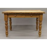 A pine two drawer kitchen table. 121 cm long.