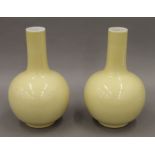 A pair of Chinese yellow ground porcelain vases, each with seal mark to base. 27 cm high.