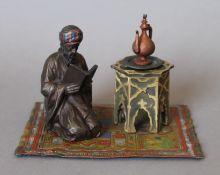 A cold painted bronze Arab form inkwell. 14.5 cm wide.