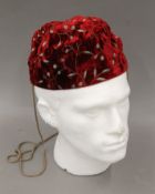 A red Favourbrook of Jermyn Street embroidered velvet smoking cap. Approximate size 7 1/8.