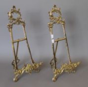 A pair of brass table easels. Each 52 cm high.