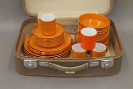 A suitcase containing a 1970's Melamine picnic set.