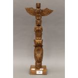 A vintage American Indian carved wood totem of typical form, possibly Haida. 46.5 cm high.