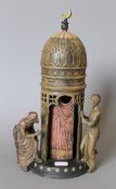 A cold painted bronze model of Arabs and a tower. 29 cm high.