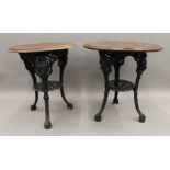 Two maids heads cast iron pub tables. The largest 66 cm diameter.