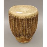 An African hide covered drum. 28 cm high.