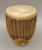 An African hide covered drum. 28 cm high.