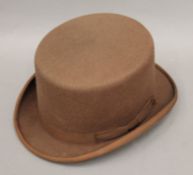 A Bermans & Nathans brown felt top hat. Approximate size 7 1/2.