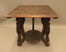 An Eastern carved hardwood table. 64 cm wide.