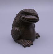 A bronze model of a toad. 4.5 cm high.