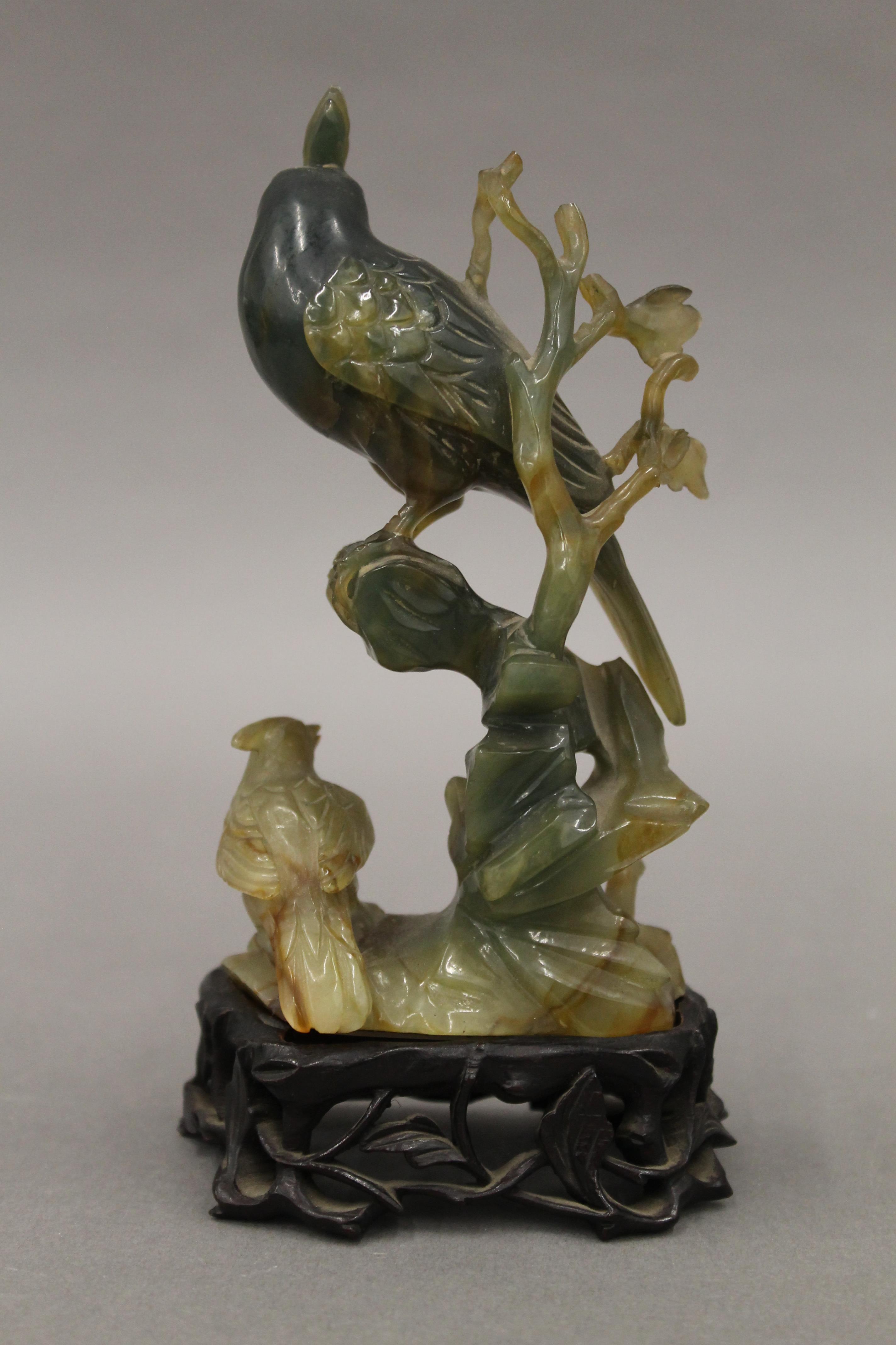 A Chinese carved jade model of birds mounted on a carved wooden stand. 15 cm high overall. - Image 3 of 3