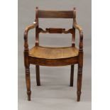 A 19th century mahogany solid seated open armchair. 51.5 cm wide.