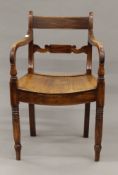 A 19th century mahogany solid seated open armchair. 51.5 cm wide.