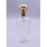 An 18 ct gold topped French scent bottle. 9.5 cm high.