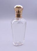 An 18 ct gold topped French scent bottle. 9.5 cm high.