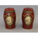 A pair of red tea tins. 16.5 cm high.