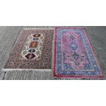 A red ground Persian rug and a white ground Persian rug. The former 186 x 96 cm.