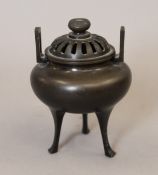 A pierced top silver inlaid bronze censer. 12 cm high.