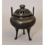 A pierced top silver inlaid bronze censer. 12 cm high.