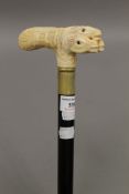 A walking stick with a carved bone handle formed as horse's heads. 90 cm long.