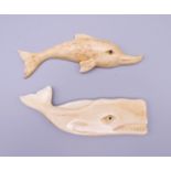 A carved bone model of a whale and a carved bone model of a dolphin. The former 8 cm long.