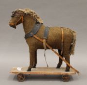 A 19th century plush covered pull along toy horse. 29 cm long.