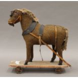 A 19th century plush covered pull along toy horse. 29 cm long.