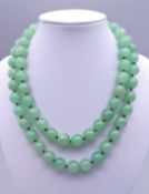 A string of jade beads. 82 cm long.